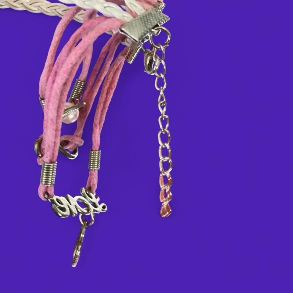 Pink and white braided bracelets with heart and love charms